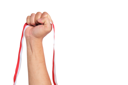 Human hand holding a red and white ribbon as a symbol of the Indonesian flag isolated on transparent background