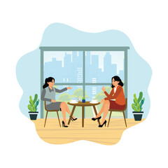 Two young women enjoy their free time in a cafe.