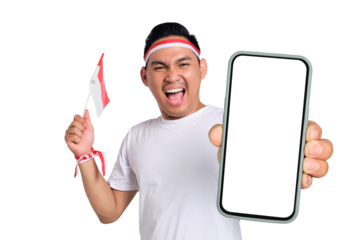 Excited young Asian man celebrate Indonesian independence day on 17 August while holding smartphone with blank screen and Indonesian flag isolated on transparent background
