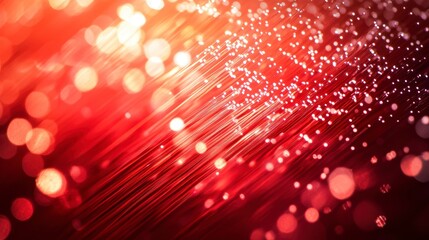 Abstract red fiber optic cables glowing with bokeh lights.