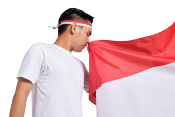 Young Asian men celebrate Indonesian independence day on 17 August while kissing the Indonesian flag isolated on transparent background