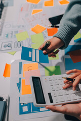 UX UI designer testing prototype on a phone, discussing and brainstorming on wireframes for a...