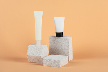 Plastic white tube for cream or lotion. Skin care or sunscreen cosmetic with stylish props on cream...