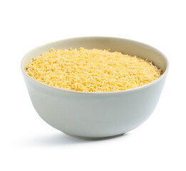 Bowl of raw alphabet pasta on white background