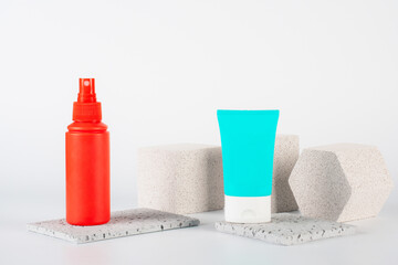 Plastic white tube for cream or lotion. Skin care or sunscreen cosmetic, Cosmetic red bottle....