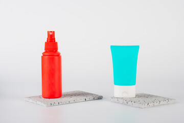 Plastic white tube for cream or lotion. Skin care or sunscreen cosmetic, Cosmetic red bottle....