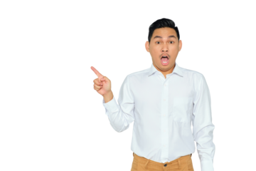 Portrait of surprised young Asian man in formal wear pointing fingers aside at copy space, presents something isolated on transparent background