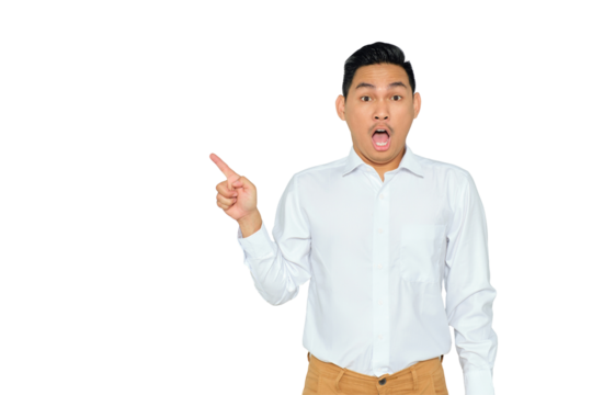 Portrait of surprised young Asian man in formal wear pointing fingers aside at copy space, presents something isolated on transparent background