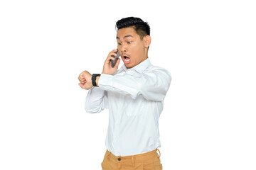 Portrait of shocked young Asian man in formal wear talking on smartphone and looking at watch isolated on transparent background