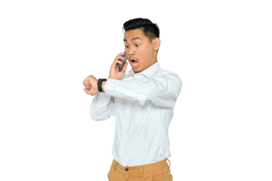 Portrait of shocked young Asian man in formal wear talking on smartphone and looking at watch isolated on transparent background