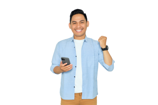 Happy young Asian man in casual clothes holding smartphone for trading or chatting and making winning gesture isolated on transparent background