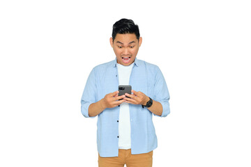 Surprised young Asian man in casual clothes looking at mobile phone, reading good news with amazed...