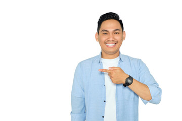 Portrait of happy young Asian man in casual clothes pointing fingers aside at copy space, presents something isolated on transparent background