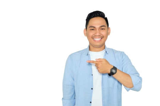 Portrait of happy young Asian man in casual clothes pointing fingers aside at copy space, presents something isolated on transparent background