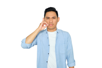 Portrait of serious young Asian man in casual clothes making zipping mouth gesture, promising to keep secret isolated on transparent background