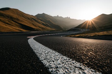 Winding road through mountains at sunrise