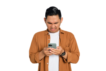 Unhappy young Asian man in casual shirt looking at smartphone getting bad news isolated on transparent background