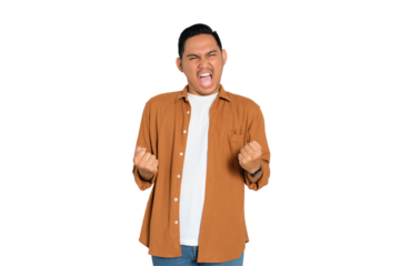 Big win. Excited young Asian man in casual shirt celebrating success with raised fist isolated on transparent background
