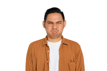 Close up of angry young Asian man in casual shirt looking at camera isolated on transparent background