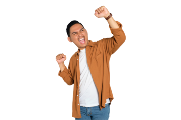Big win. Excited young Asian man in casual shirt celebrating success with raised fist isolated on transparent background