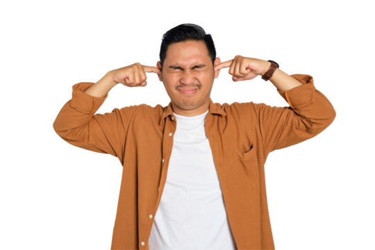 Irritated young Asian man in casual shirt plugging ears with fingers, disturbed by loud noise isolated on transparent background