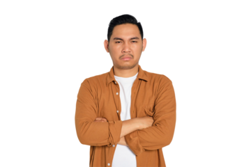 Annoyed young Asian man in casual shirt with arms crossed, looking at camera isolated on transparent background