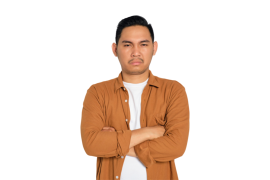Annoyed young Asian man in casual shirt with arms crossed, looking at camera isolated on transparent background