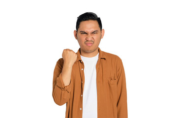 Upset young Asian man in casual shirt raising fist with angry expression isolated on transparent...