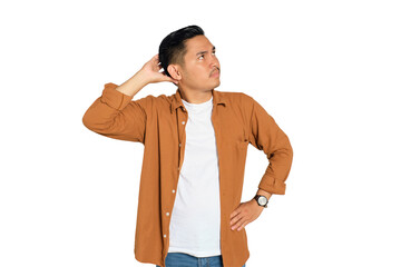 Doubtful young Asian man in casual shirt scratching head, thinking, trying to find solution...