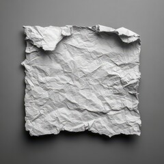 Obraz premium Crumpled white paper square on gray