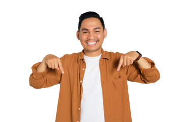 Happy young Asian man in casual shirt pointing finger down and smiling at camera isolated on transparent background