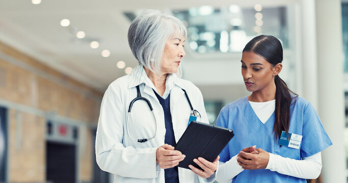 Women, nurse or doctor with tablet for research discussion or healthcare mentorship at hospital. Female people, intern or medical worker with technology for staff training on telehealth app at clinic