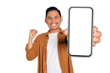 Yes. Excited young Asian man in casual shirt holding smartphone with blank screen and clenching fist, celebrating victory isolated on transparent background