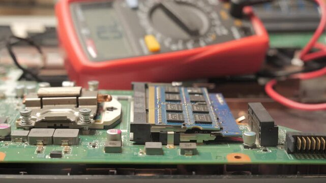 Close-Up of Circuit Board Testing with Multimeter Probes, Gloved hands using multimeter probes to test components on a computer motherboard.