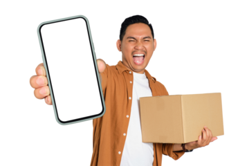 Happy young Asian man in casual shirt holding smartphone with blank screen and cardboard box isolated on transparent background