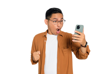 Surprised young Asian man in casual shirt using mobile phone with open mouth, reading great news message isolated on transparent background