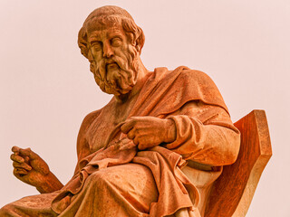 Seated marble statue of Plato, the ancient Greek philosopher, located in Athens, Greece. A classical representation of wisdom and intellectual heritage.