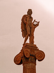 A majestic marble statue of Apollo, the ancient Greek god of music and fine arts, standing elegantly on a column while holding a lyre, symbolizing harmony and artistic mastery.