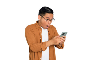 Surprised young Asian man in casual shirt using mobile phone with open mouth, reading great news...