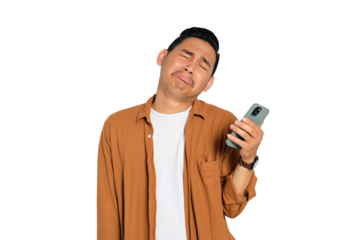 Unhappy young Asian man in casual shirt holding smartphone, receiving negative message, sad facial expression isolated on transparent background