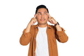 Doubtful young Asian man in casual shirt put his finger on his temple, trying to remember something...