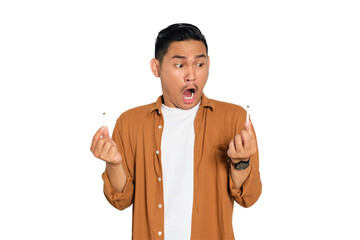 Quit smoking. Angry young Asian man in casual shirt breaking cigarette and saying no to smoking...