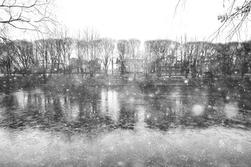 snowfall in the park, snowflakes on the background of branches, heavy thick snowfall abstract blurred background