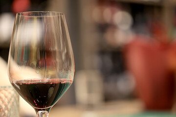 dinner in a restaurant with wine, beautiful table setting, a glass of wine in the foreground