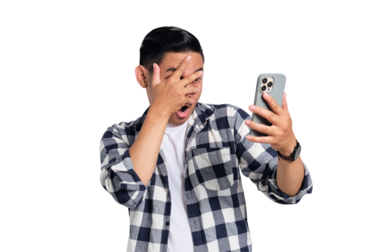 Scared young Asian man in casual shirt looking at mobile phone screen isolated on transparent background
