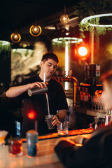 Bartender Preparing a Drink in a Modern Decor Bar Setting