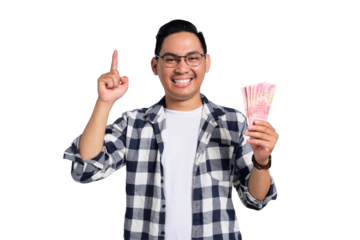 Successful financial planning. Smiling young Asian man in casual shirt holding money and pointing finger up isolated on transparent background