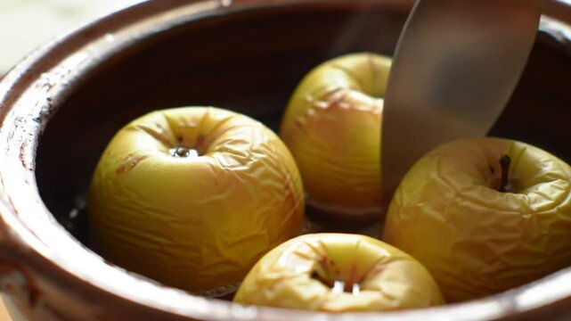 Dessert in Clay Pot Grill. Fresh Apples in a Clay Pot with a Knife, Ready for Slicing.