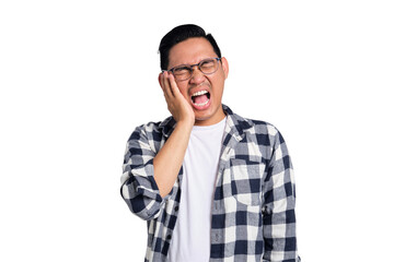 Dental problems. Unhappy young Asian man in casual shirt suffering from severe toothache, touching...