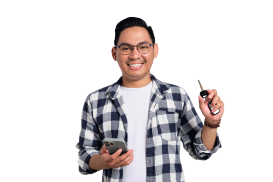 Smiling young Asian man in casual shirt holding smartphone and showing car key isolated on transparent background